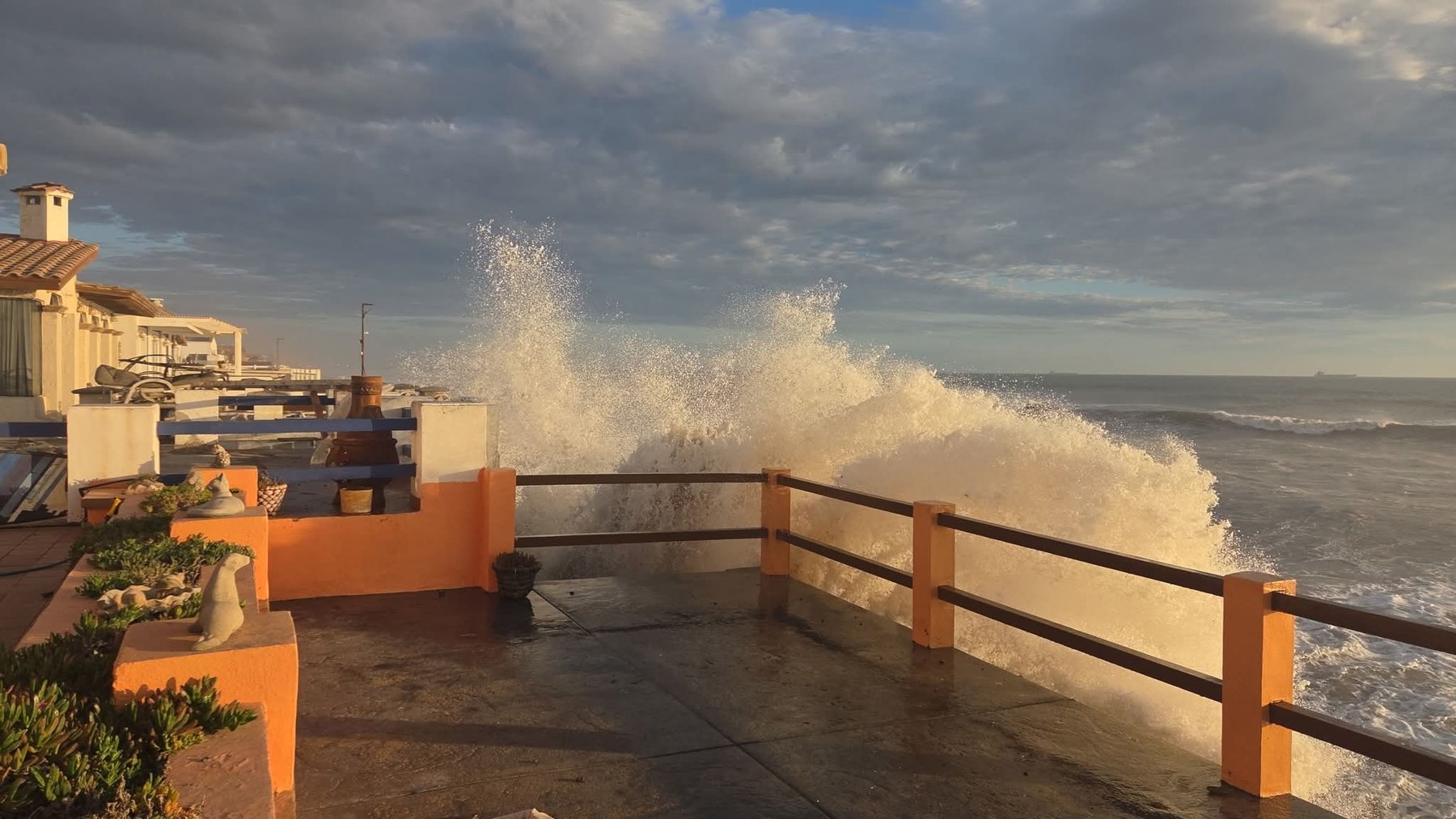 Surf breaking over the rail